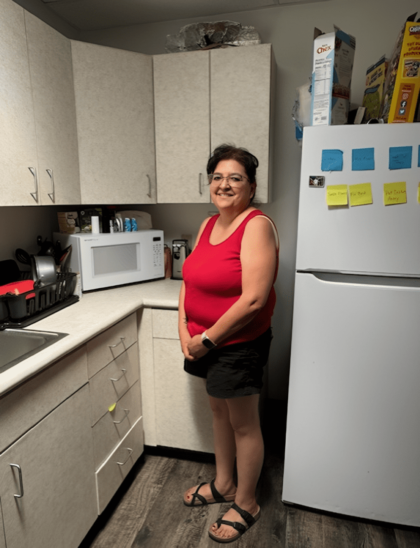 Woman standing in a small kitchen
