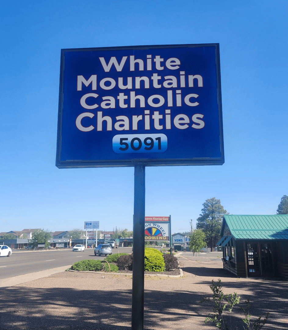 White Mountain Catholic Charities sign