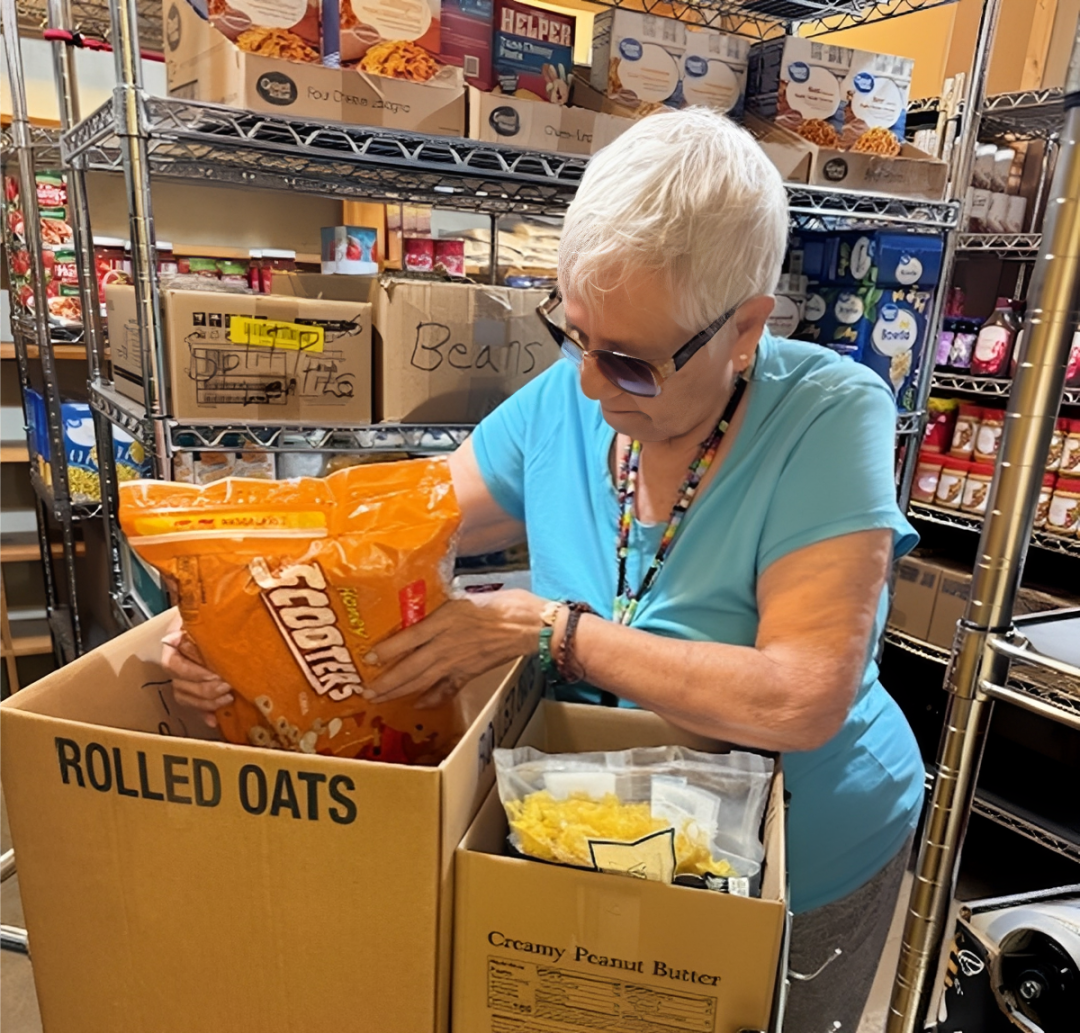 Elderly woman sorting food donations