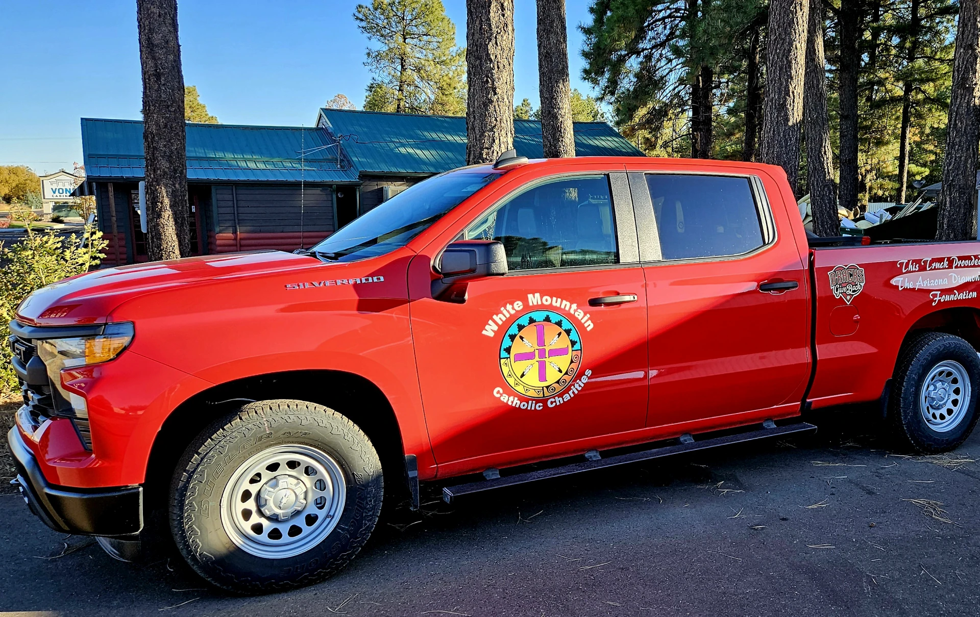 Parked red truck near trees